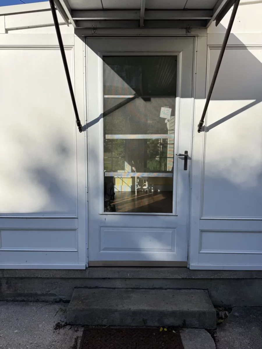 White exterior door with glass panel and metal handle