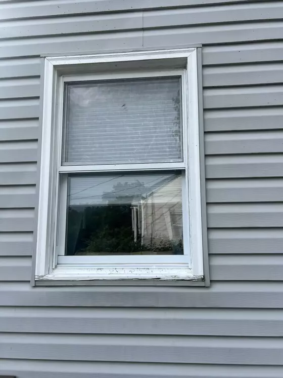 Old window with rotted window seal