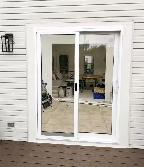 New white sliding glass patio door replacement with exterior trim