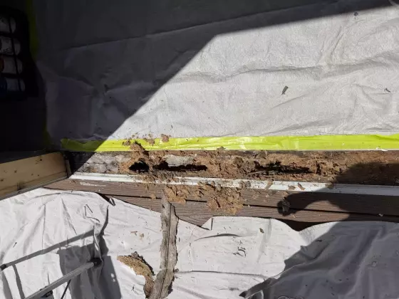 Rotted wood beneath sliding patio door