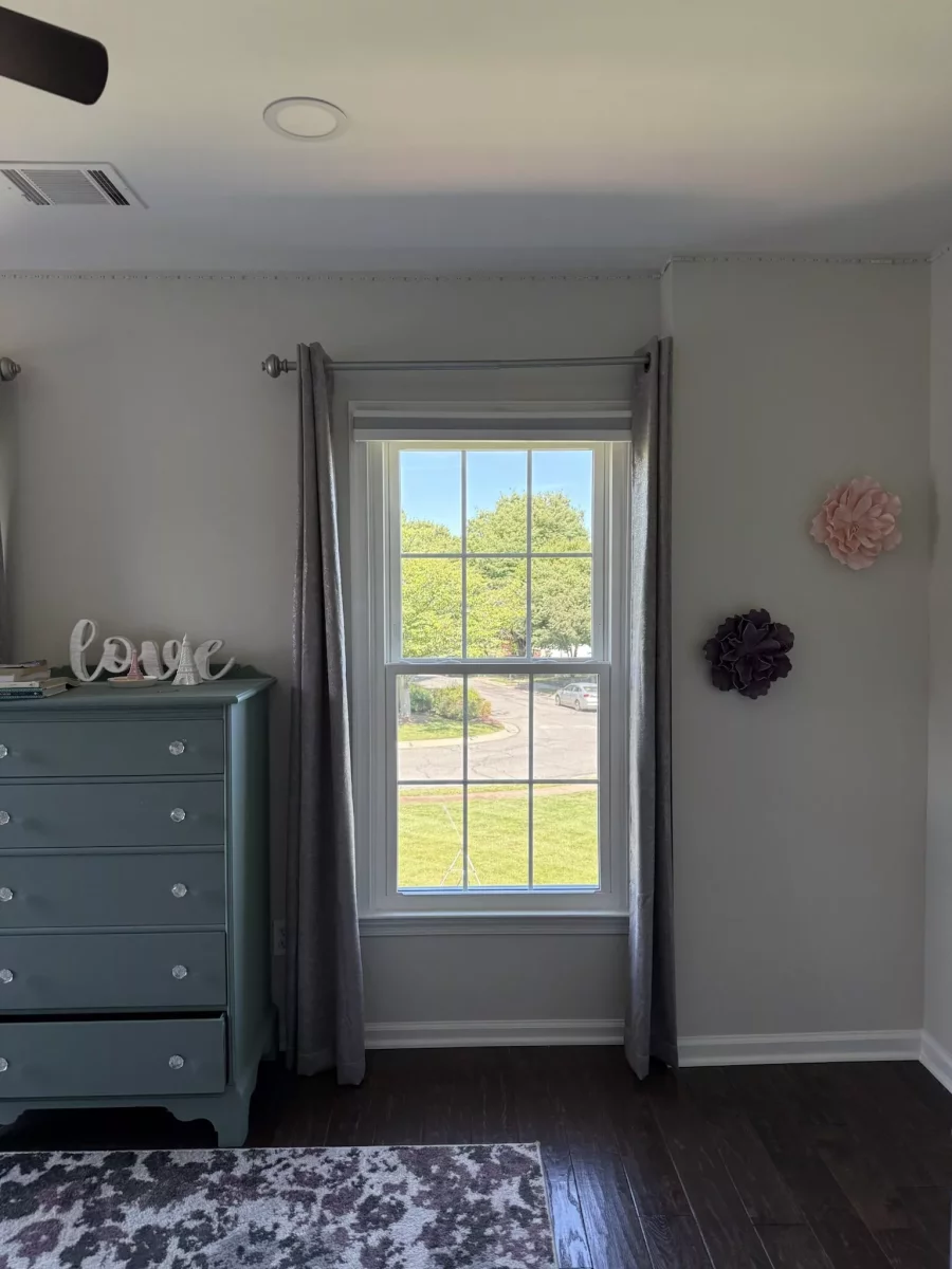 Energy-efficient double-hung window replacement in Rockville, MD, with grids and professionally finished interior trim.