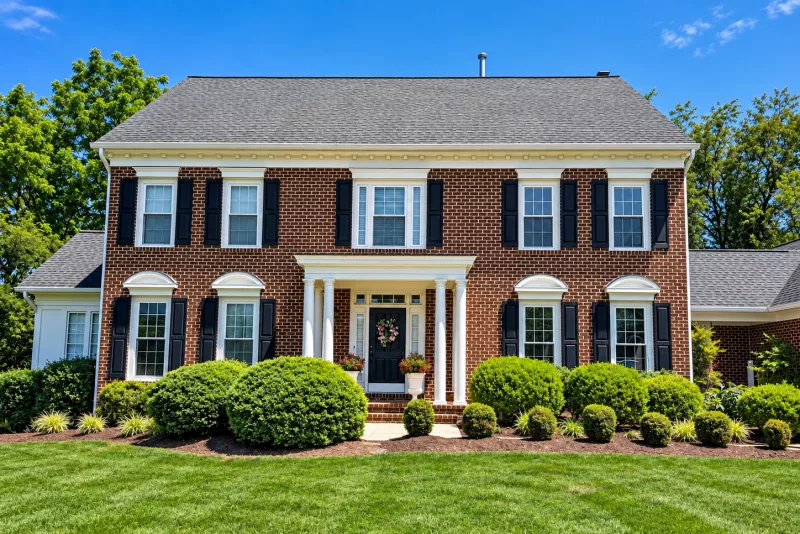 Brick colonial home with professionally installed energy-efficient replacement windows in Rockville, Maryland.