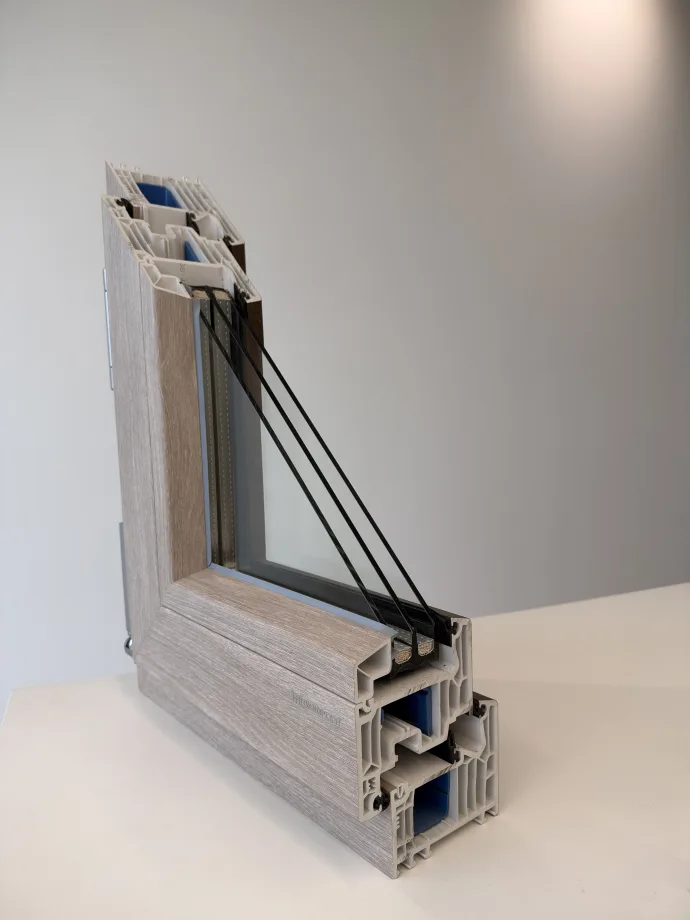 Cross-section of a multi-chamber European window frame with triple glazing, showing the layers that reduce outside noise
