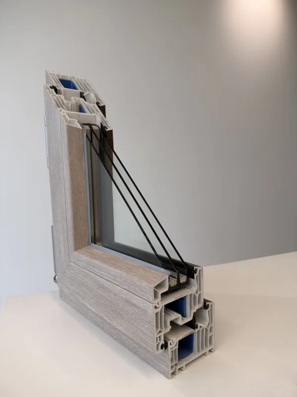 Cross-section of a multi-chamber European window frame with triple glazing, showing the layers that reduce outside noise