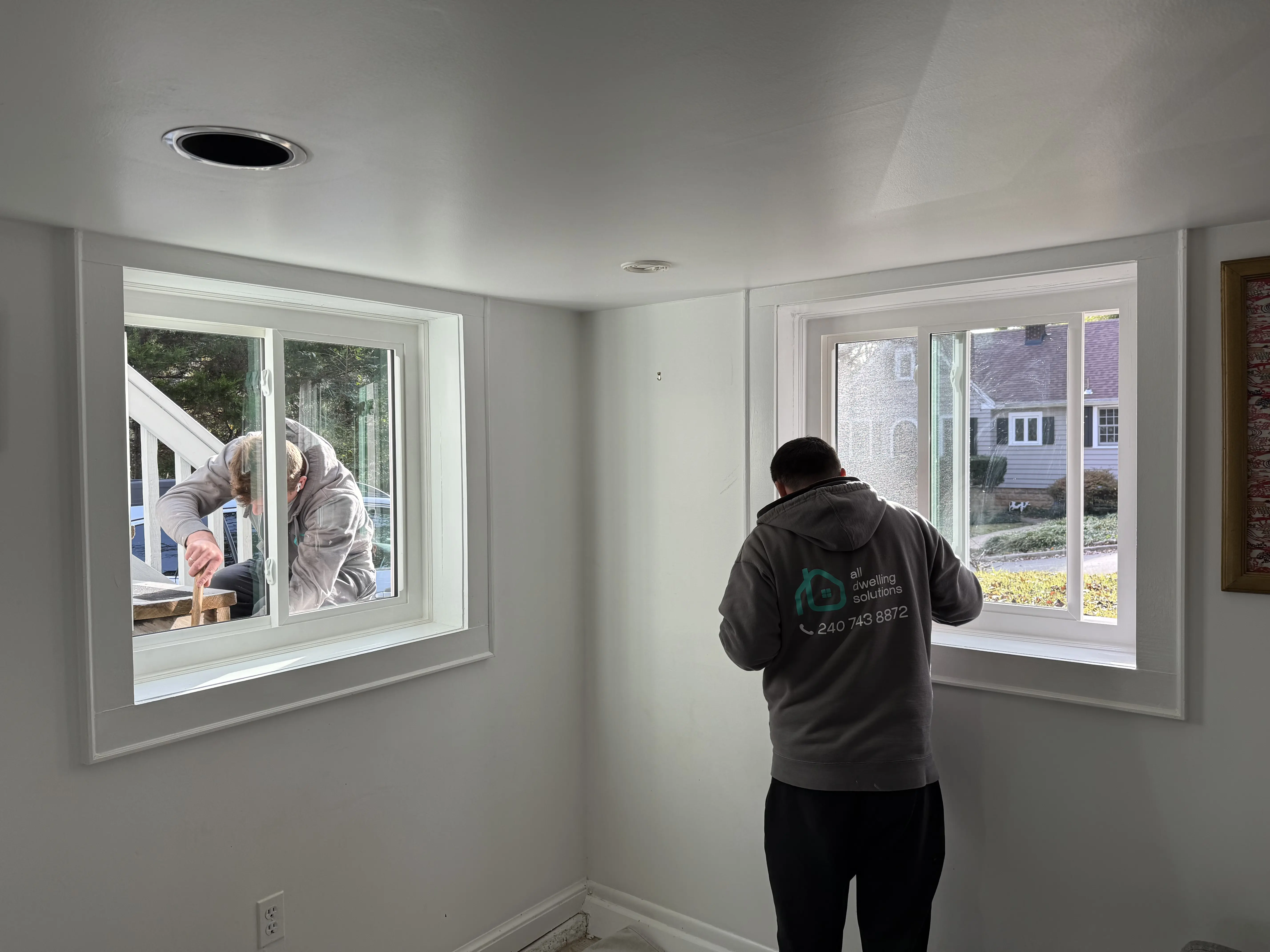 New energy-efficient vinyl double-hung window installed in living room interior.