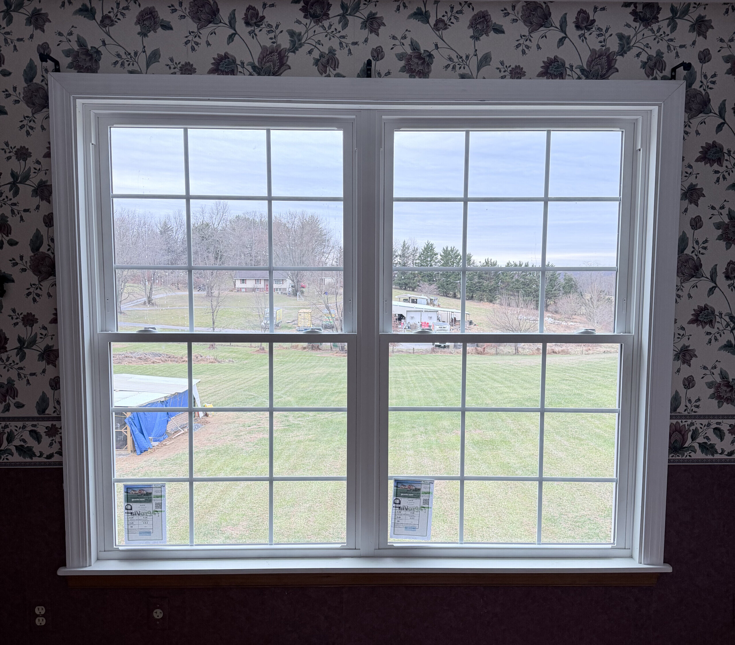 Double window installation in progress with tools and materials visible