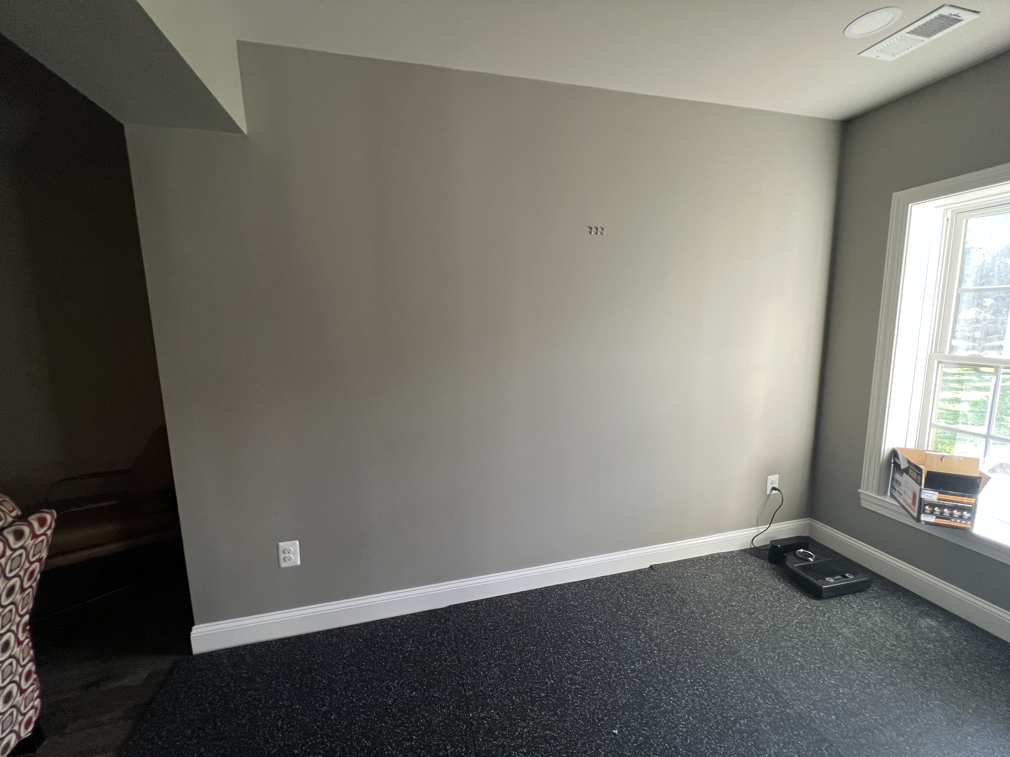Empty gym wall prepared for custom mirror installation in Frederick Maryland home.