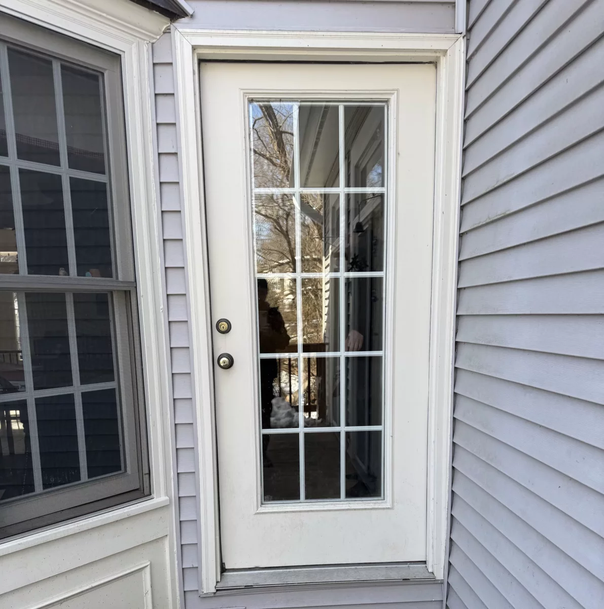 Exterior glass door and window next to wood deck