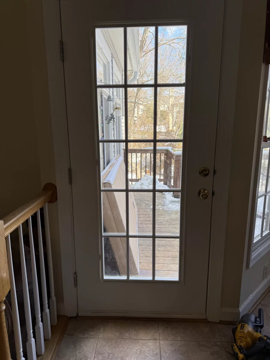 Glass patio door viewed from inside with tools on the floor