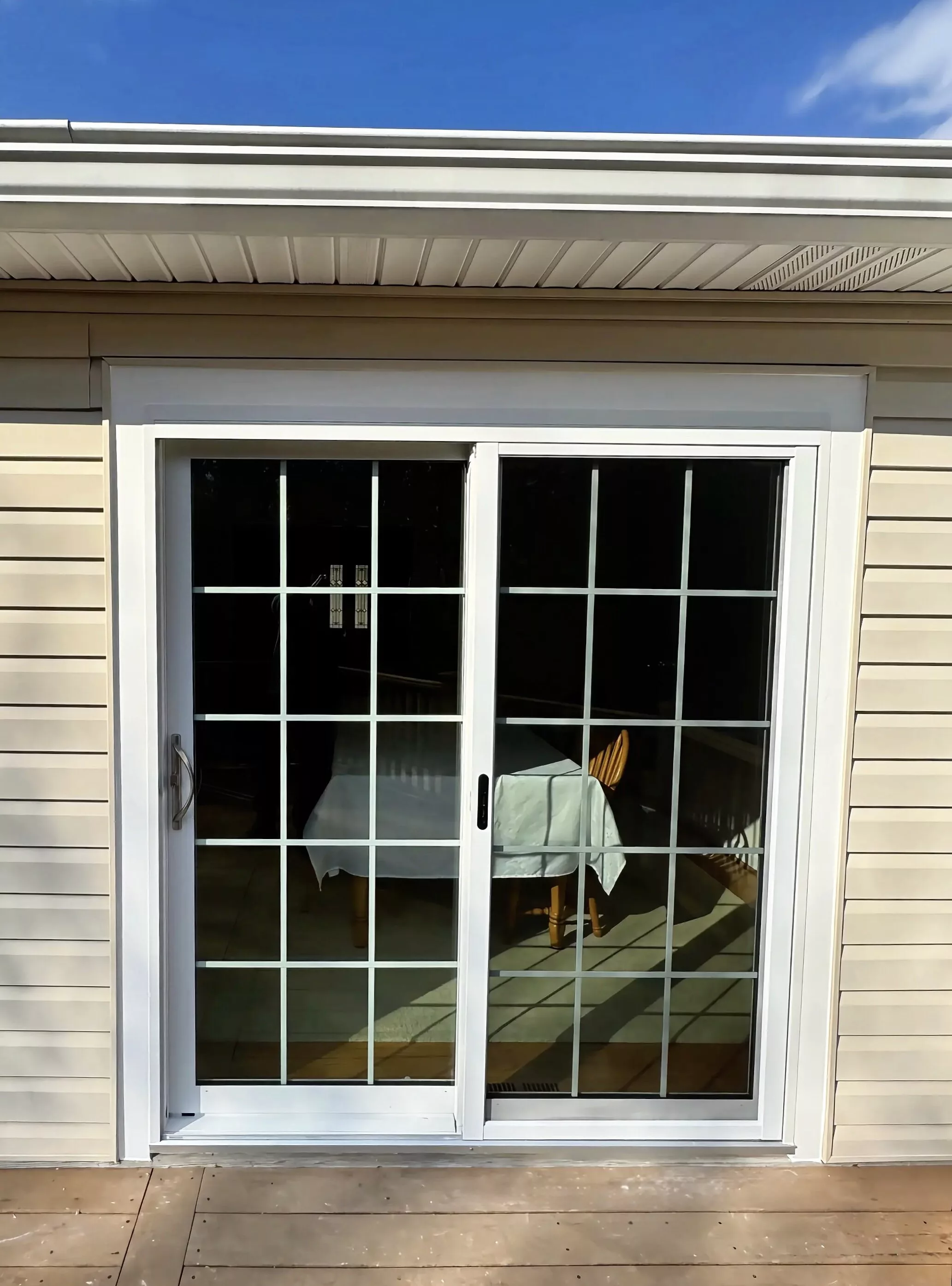 White vinyl sliding patio door with grids inside the glass