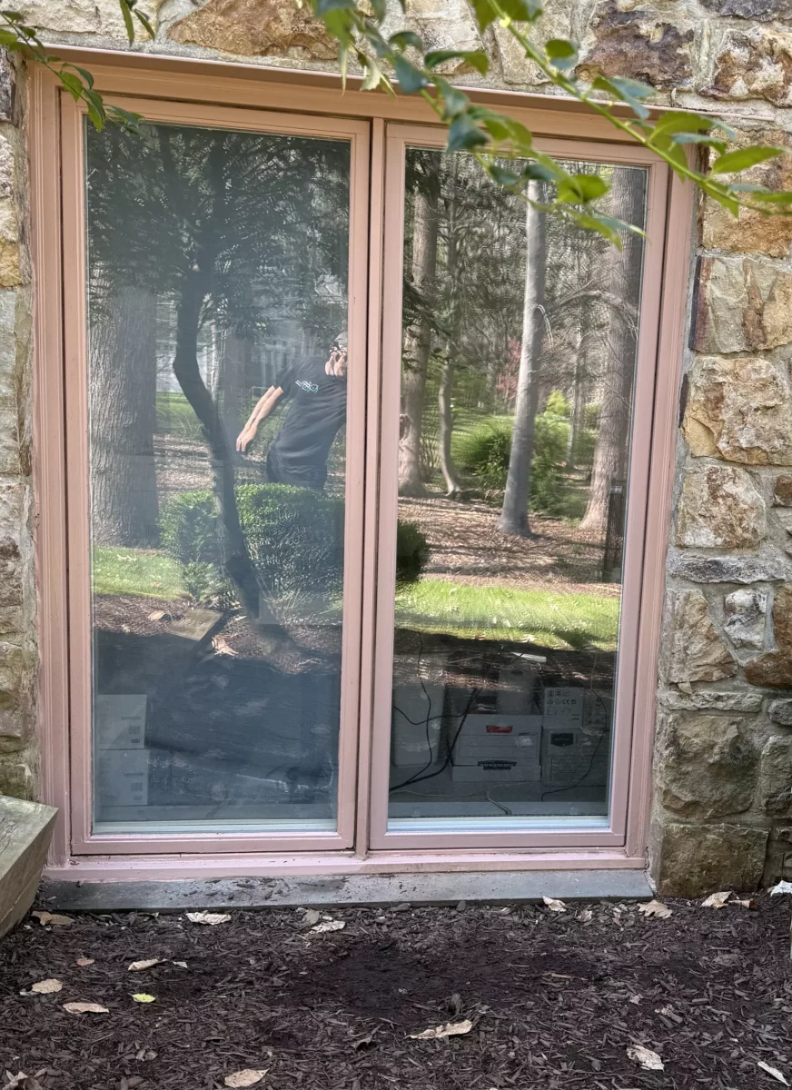 Exterior view of a sliding glass patio door in a stone facade