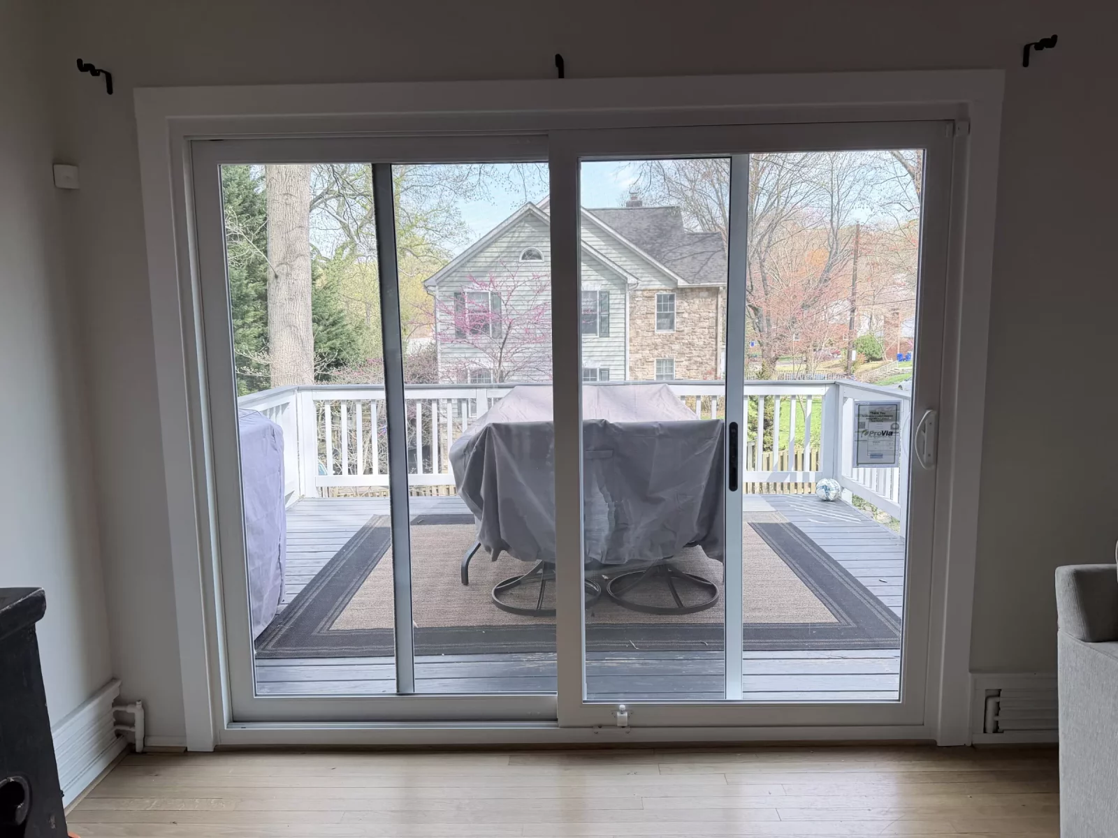 Sliding glass patio door with white frame viewed from inside