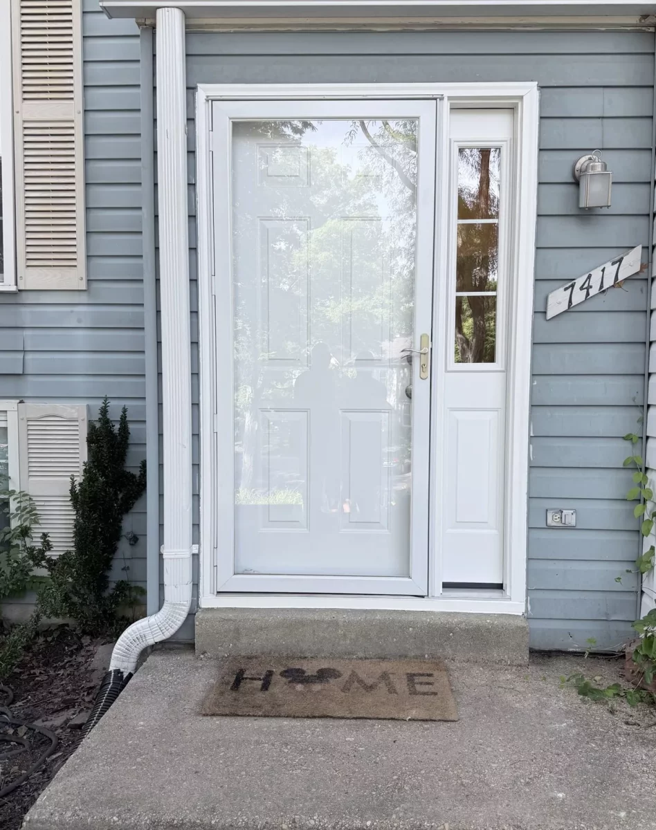 White storm door installed at the front entrance of a house