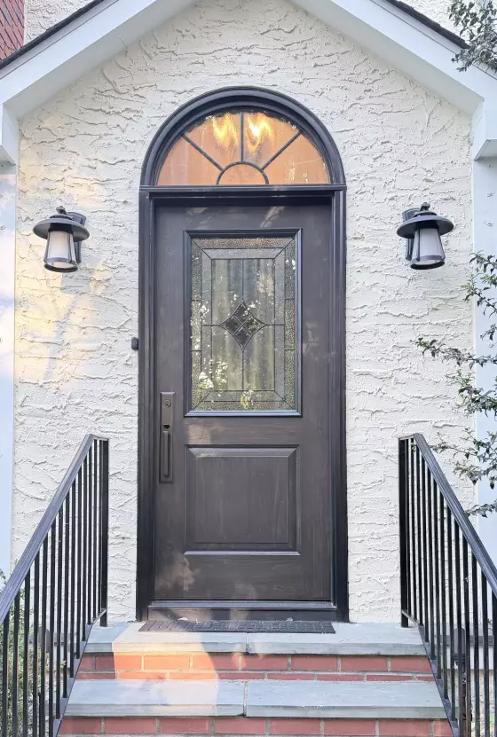 Front entry door with glass panel and arched window above