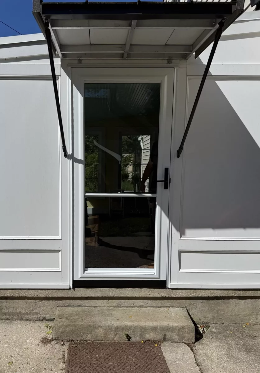 Exterior view of a white door with glass panel and handle