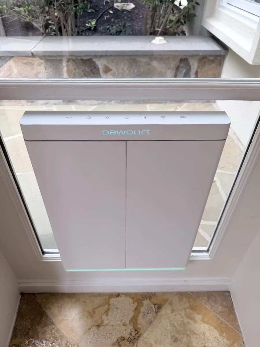 Installed pet door in glass patio door with tile floor
