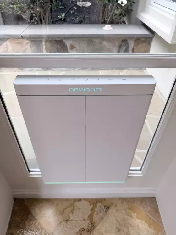 Installed pet door in glass patio door with tile floor