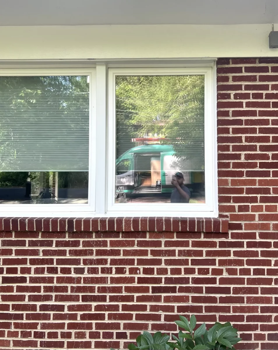 White framed window set in red brick exterior wall