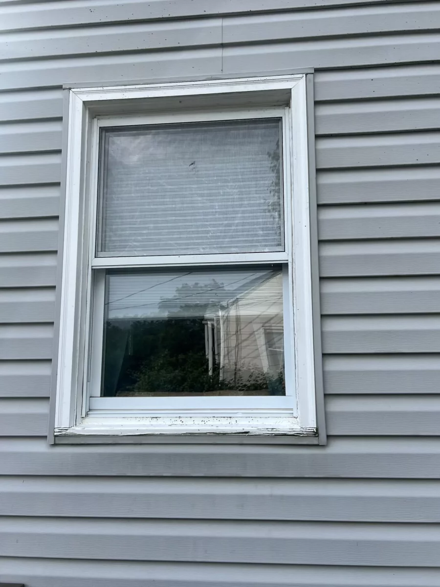Old window with rotted window seal