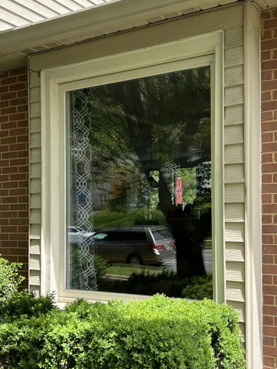 Exterior view of a residential window with trim and siding