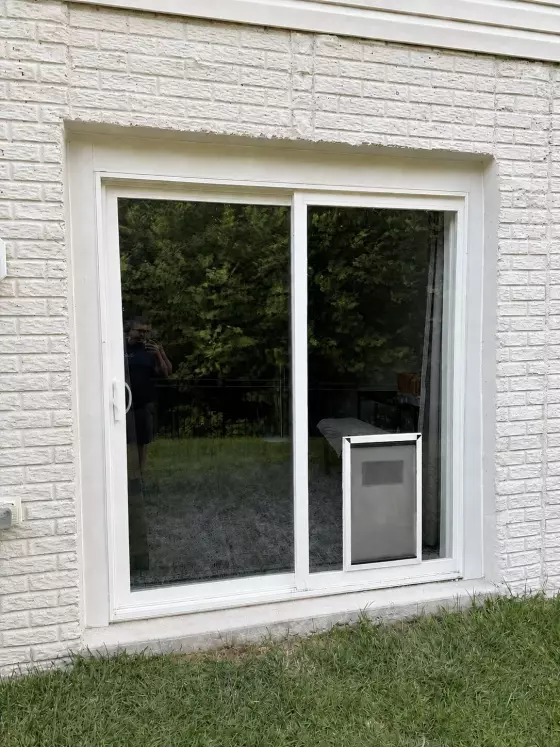 Completed custom dog door installation in a sliding glass patio door