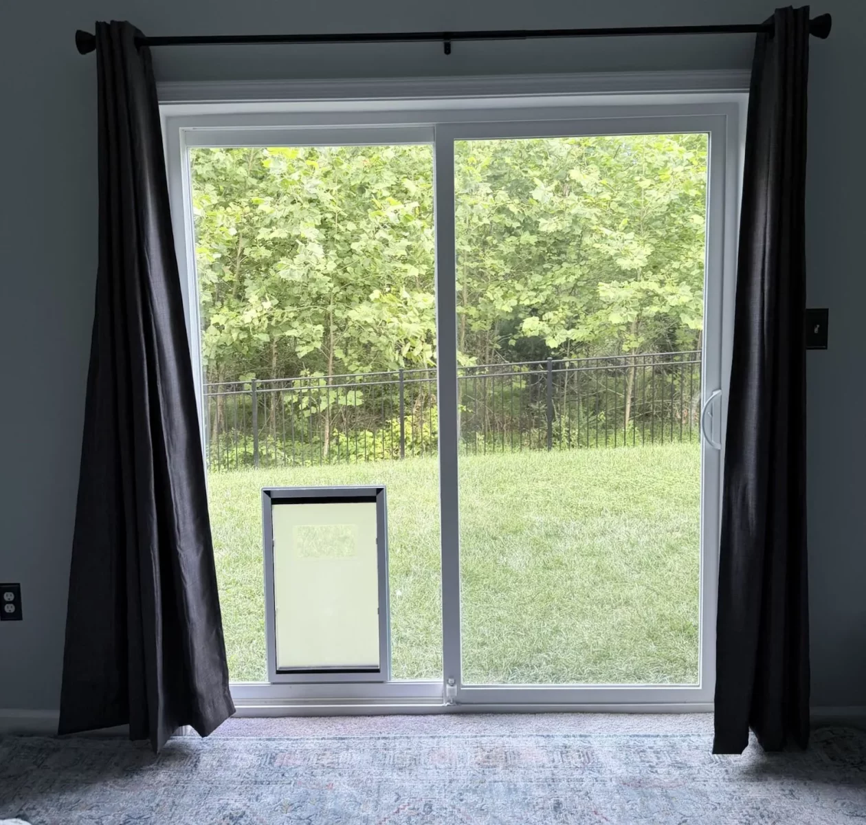Interior view of completed extra-large dog door installation in sliding glass patio door