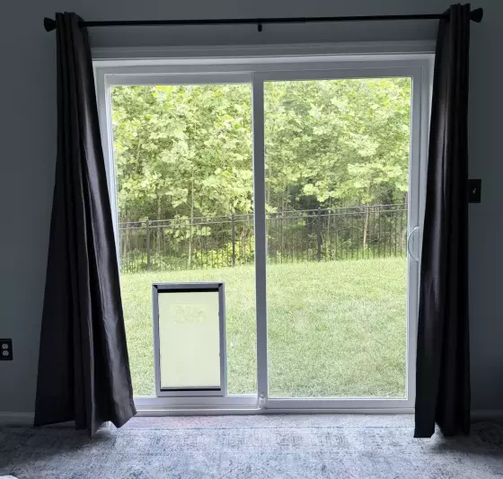 Interior view of completed extra-large dog door installation in sliding glass patio door
