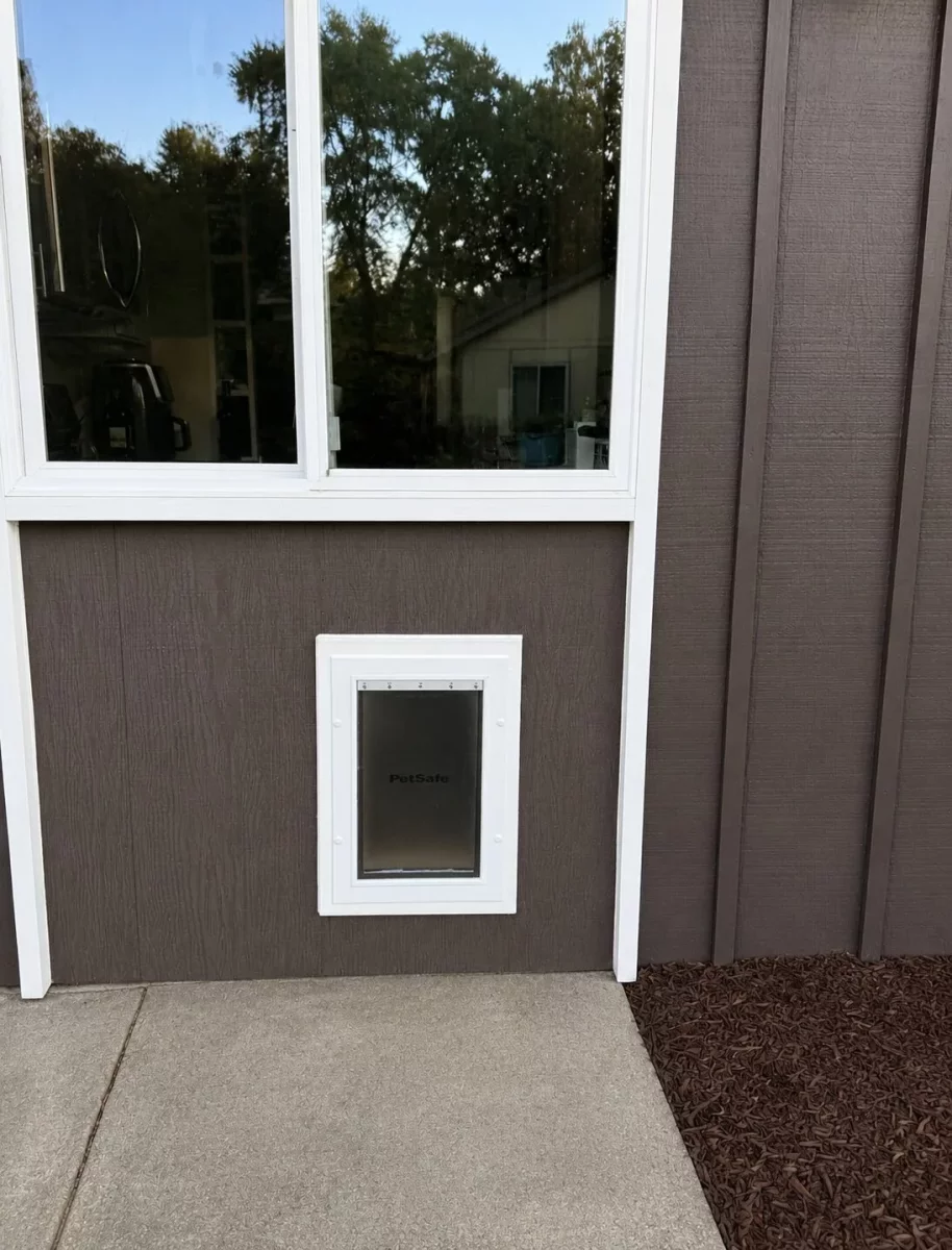 Finished custom-sized pet door with white exterior trim