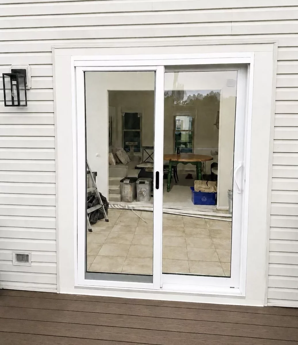 New white sliding glass patio door replacement with exterior trim