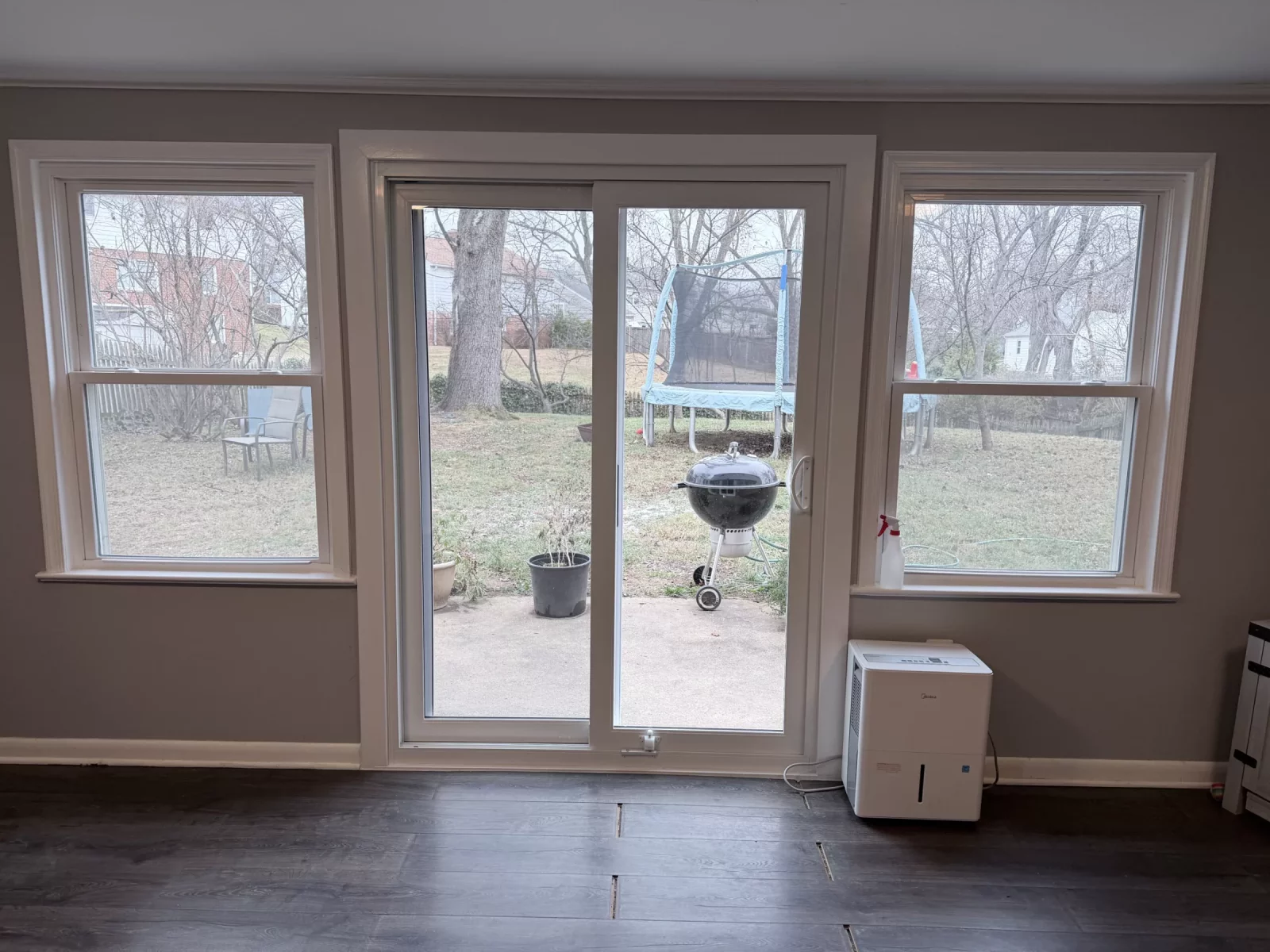 Sliding patio door and two windows in a finished interior room