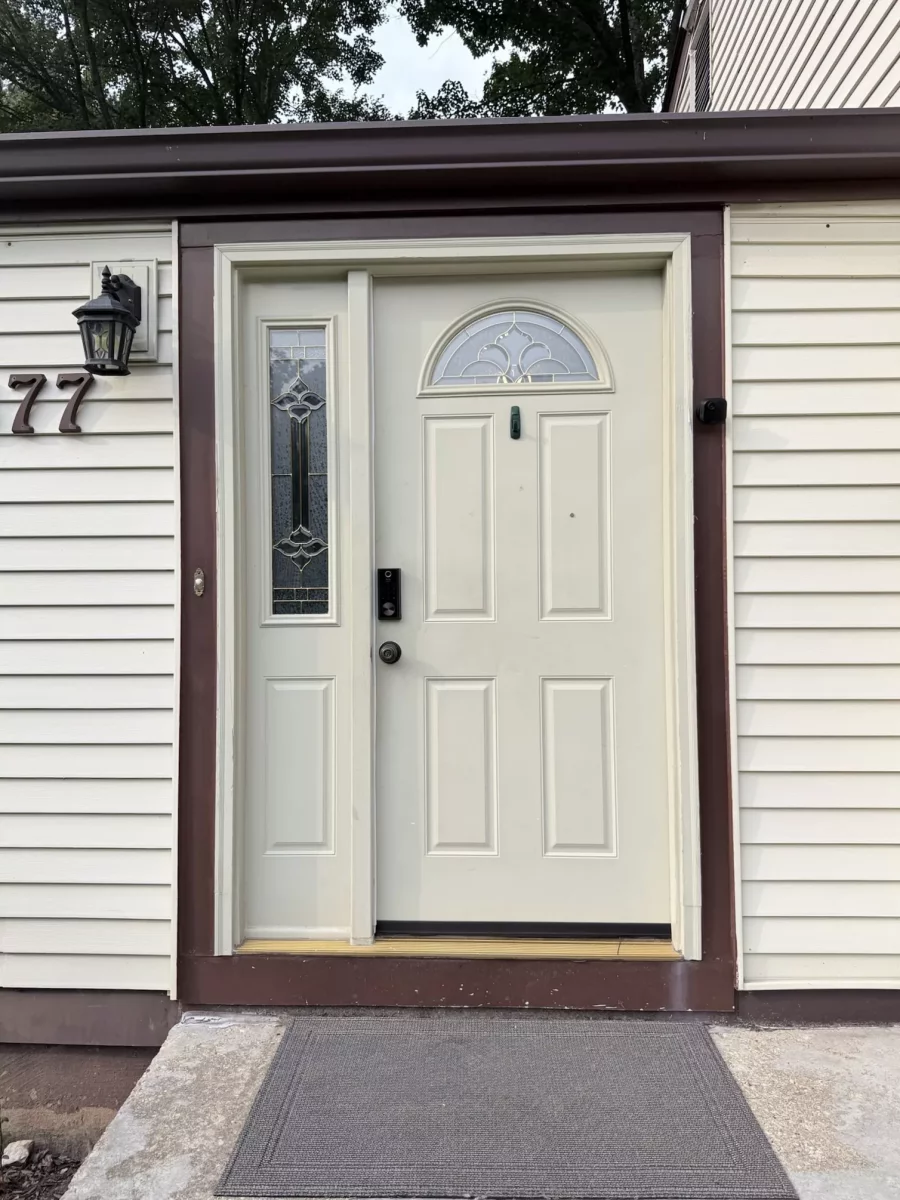 Front entry door with sidelight window and exterior siding