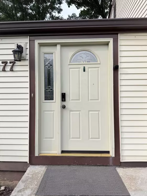 Front entry door with sidelight window and exterior siding