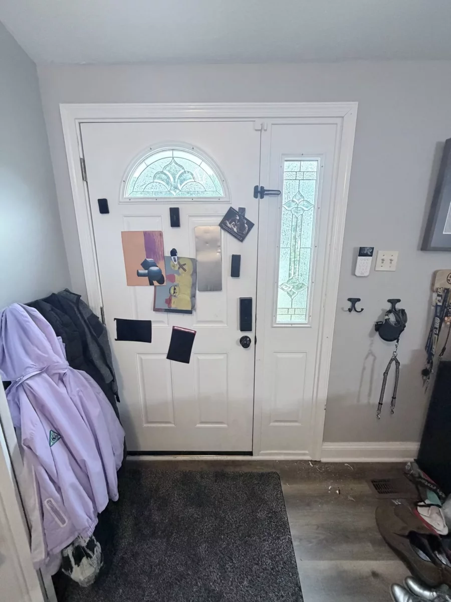 Before: Interior view of the original front entry door and decorative glass sidelight before replacement in Columbia, MD.