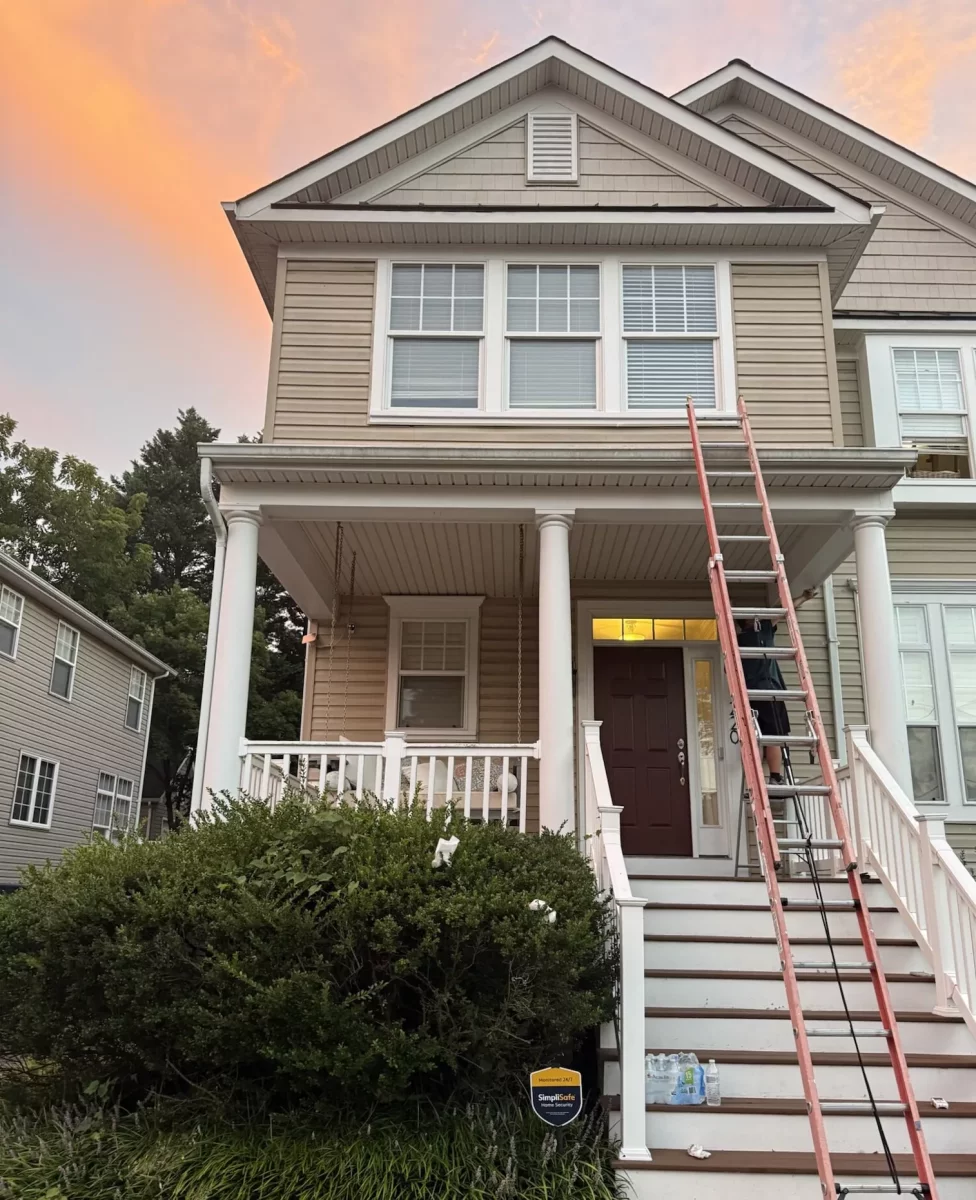Residential house exterior with ladder and windows visible