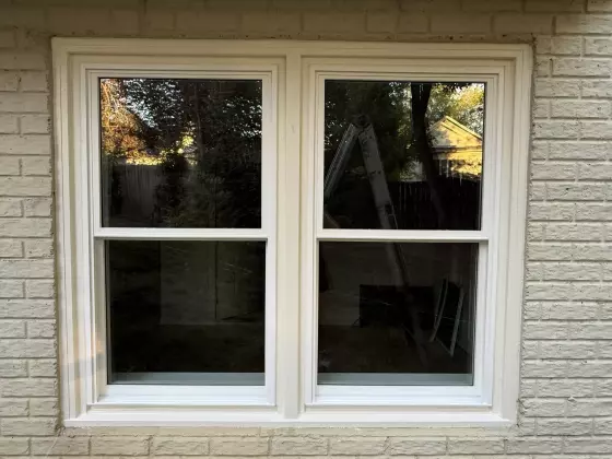 Completed full-frame double-hung window replacement with clean white exterior trim in Rockville, MD.