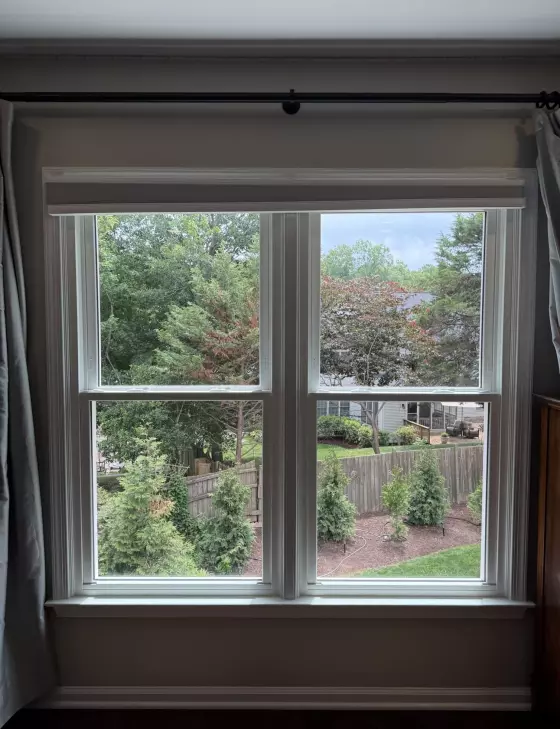 Double-hung window with white trim and outdoor view