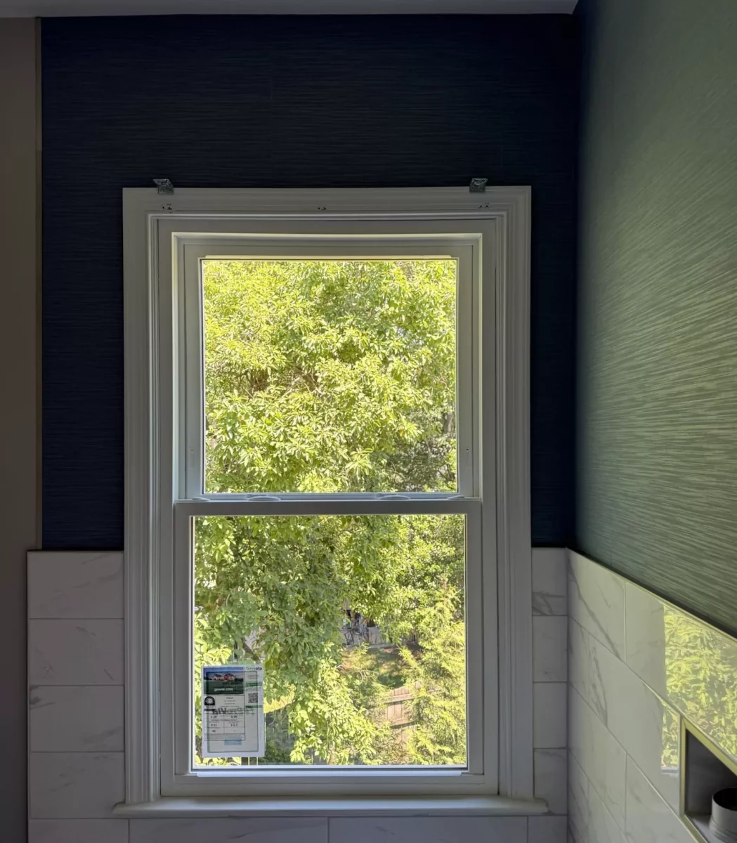 Completed energy-efficient tempered glass, double-hung window replacement in Rockville, MD, with professional interior trim and finishing.