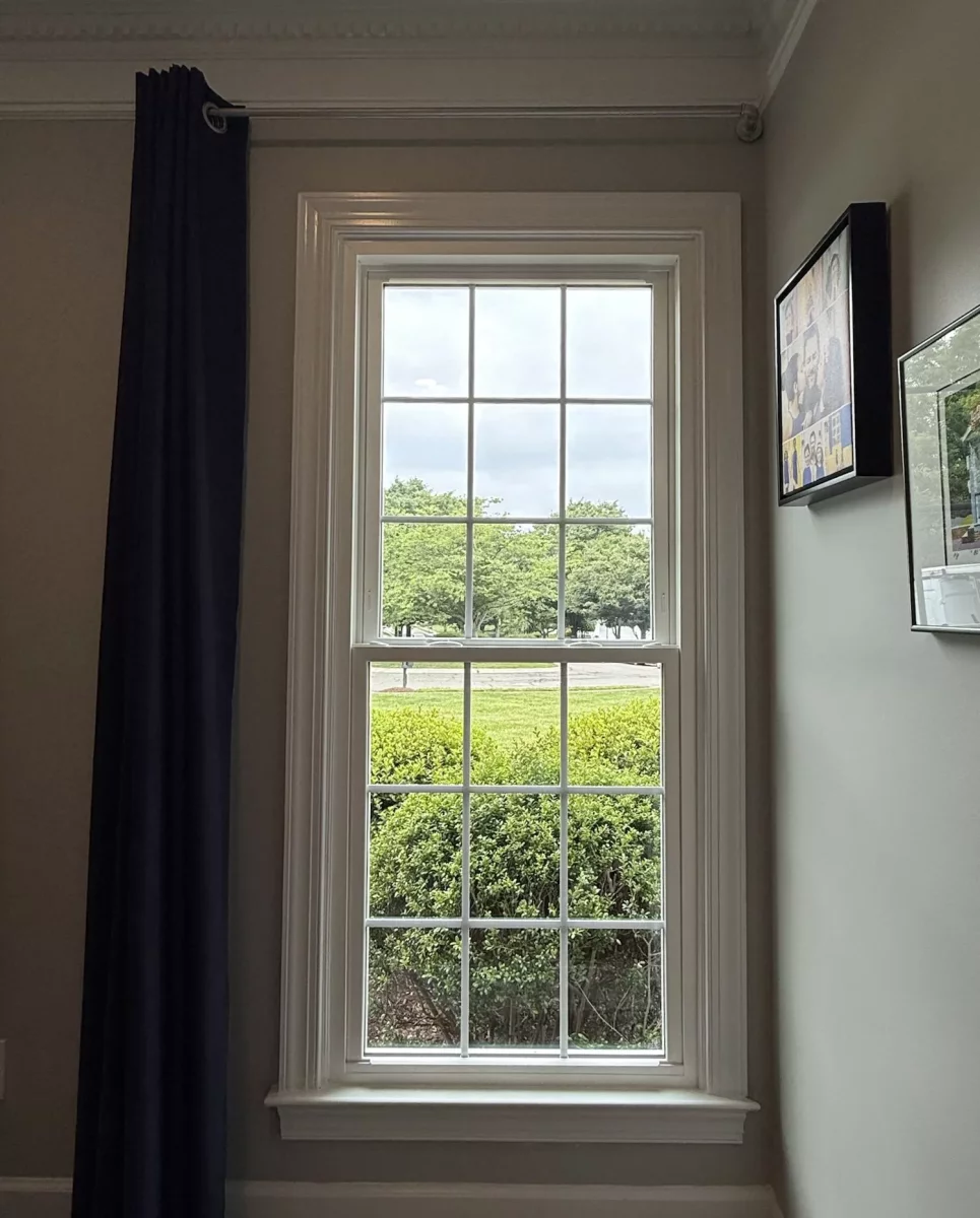 Energy-efficient double-hung window replacement in Rockville, MD, with grids and professionally finished interior trim.