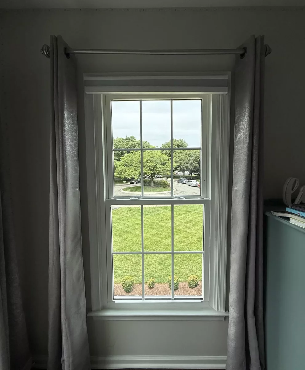 Energy-efficient double-hung window replacement in Rockville, MD, with grids and professionally finished interior trim.
