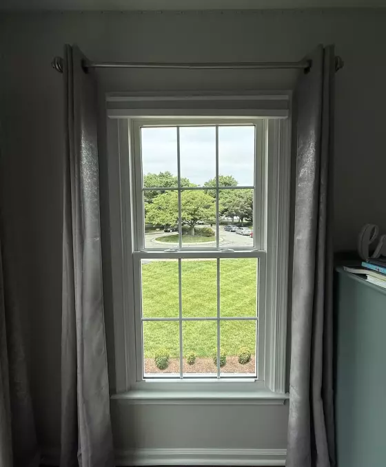 Energy-efficient double-hung window replacement in Rockville, MD, with grids and professionally finished interior trim.