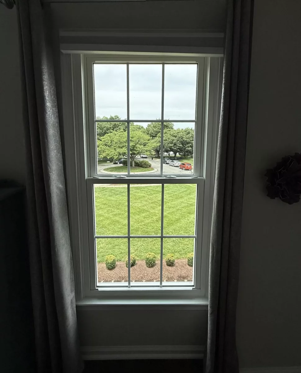 Energy-efficient double-hung window replacement in Rockville, MD, with grids and professionally finished interior trim.