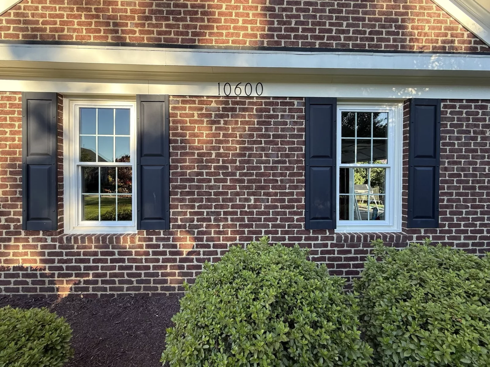 Full-frame double-hung window installation with colonial grids on a brick home in Rockville, MD.