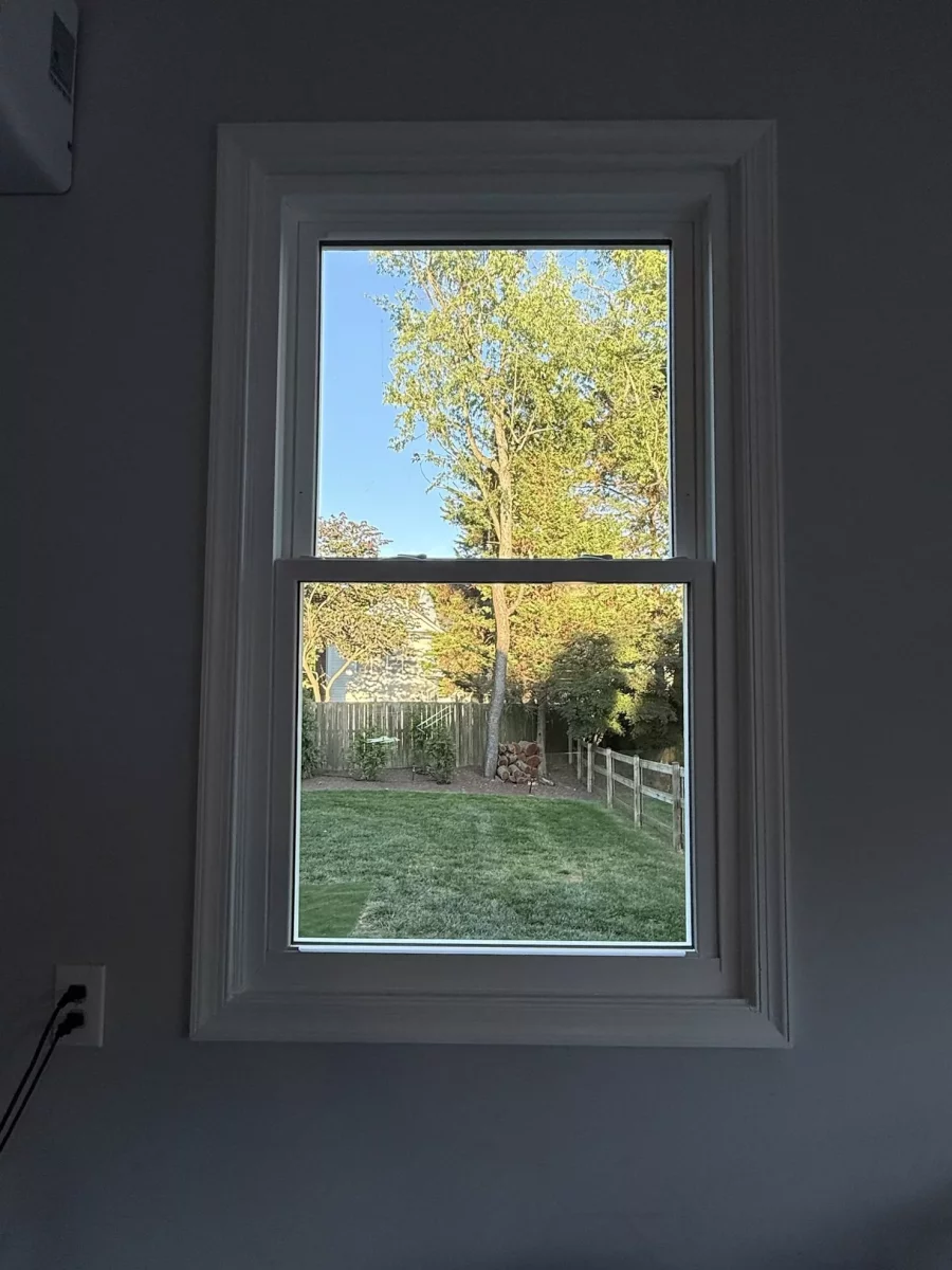 Double-hung window with white trim viewed from inside a room