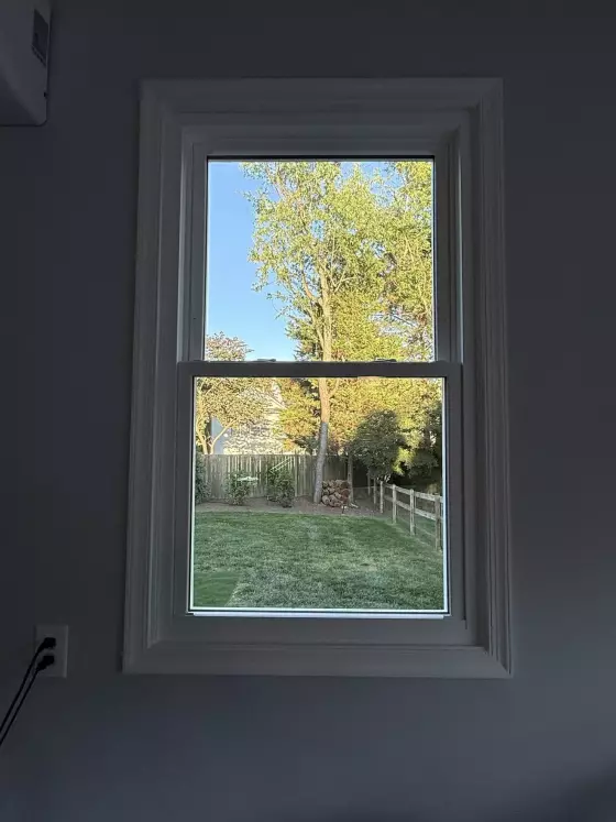 Double-hung window with white trim viewed from inside a room