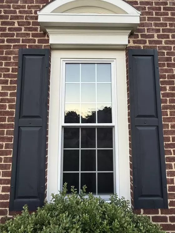 New energy-efficient double-hung window with colonial grids installed in a brick home in Rockville, MD.