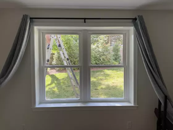 Two newly installed double-hung replacement windows with clean interior trim in Rockville, MD.
