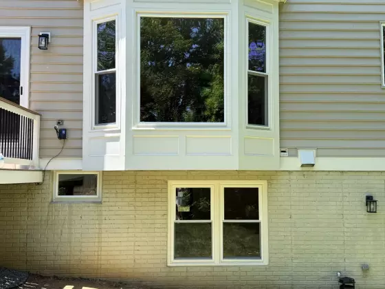 Exterior view of house with new bay window and siding