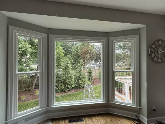 Completed bay window replacement with new double-hung side windows and a large picture window in Rockville, MD.