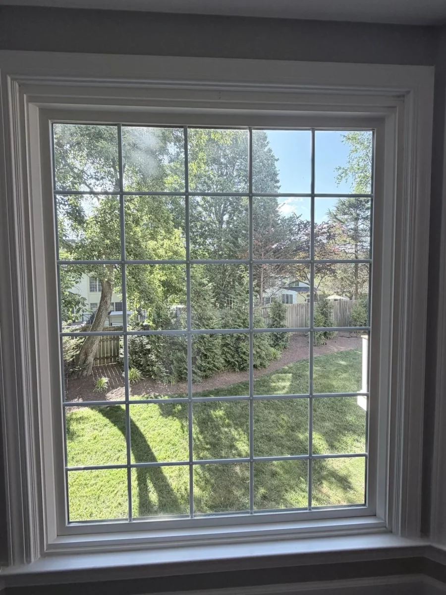 White grid window with trim viewed from inside a house