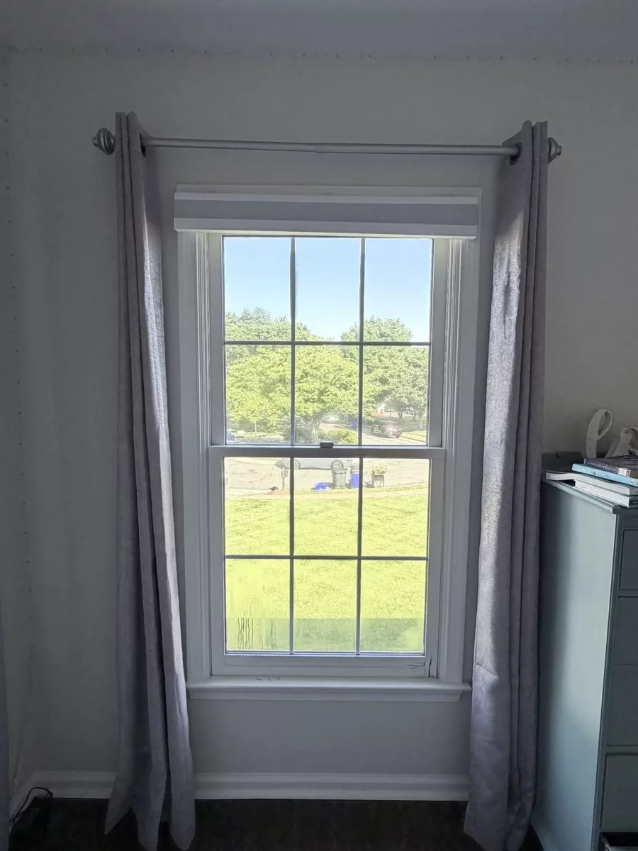 Interior view of a window with curtains and trim